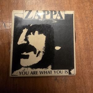 FRANK ZAPPA  LARGE VINTAGE METAL PIN BADGE FROM THE 1970's "You Are What You Is"